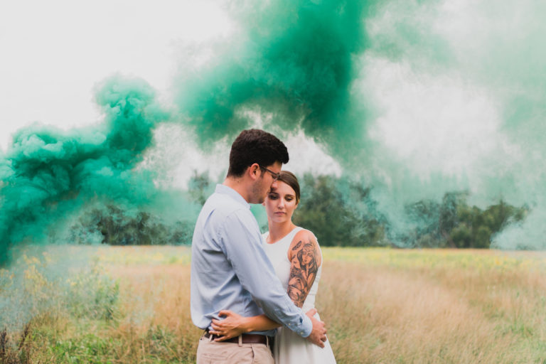 couple with smoke bomb kissing