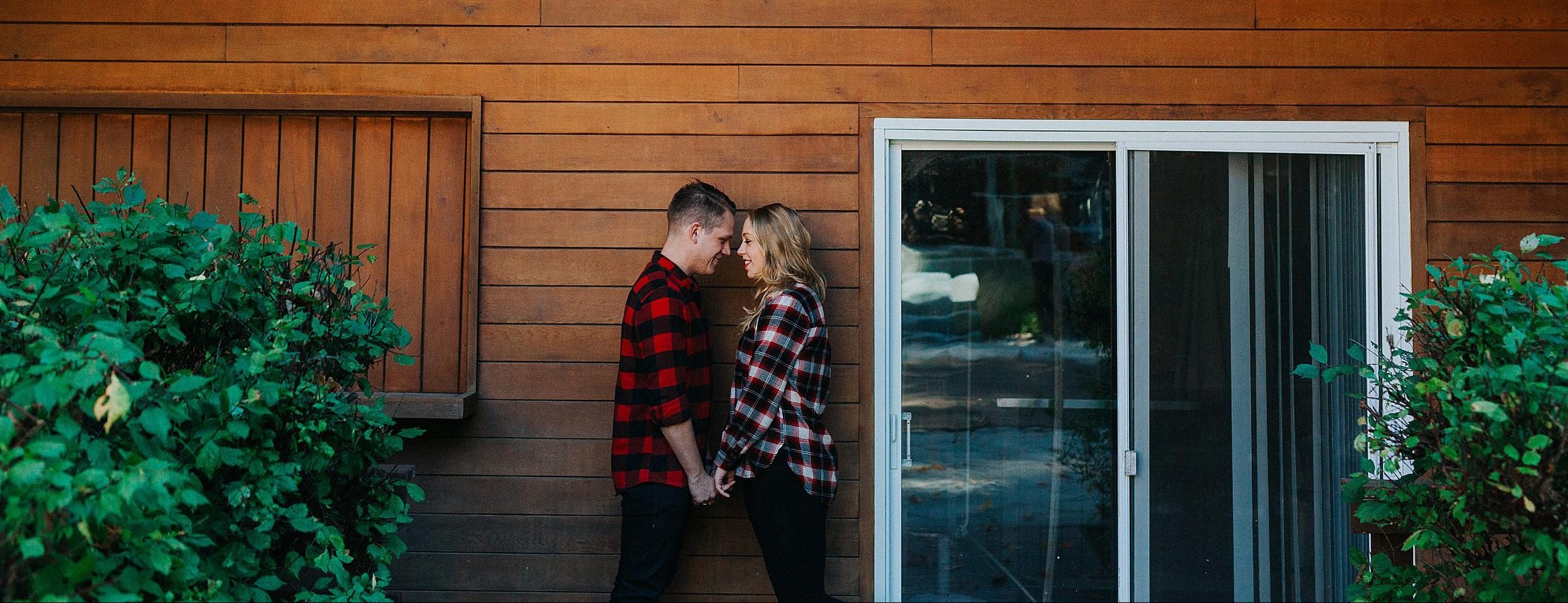 engaged couple facing each other and holding hands